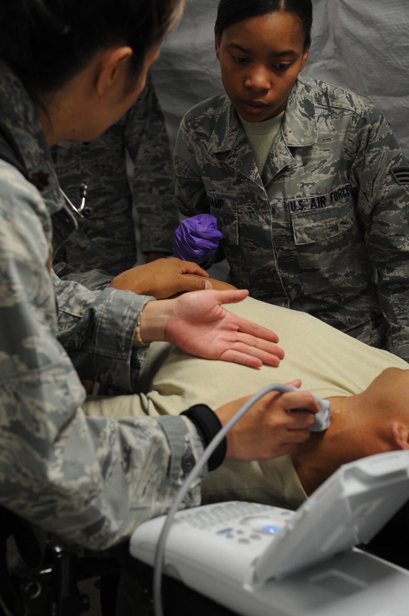 CAMP PEPELISHTE, Macedonia ? Senior Airman Krystal Champ, 31st Medical Group medical technician from Aviano Air Base, Italy, receives instructions on how to perform an ultrasound before a simulated emergency surgery during the 2011 Medical Training Exercise in Central and Eastern Europe June 13. An annual Chairman of the Joint Chiefs of Staff-sponsored regional and multilateral exercise, MEDCEUR is designed to provide medical training and operational experience in a deployed environment for U.S. and partner nations. The countries participating in this year's MEDCEUR are Macedonia, Montenegro, Bosnia and Herzegovina, Serbia, Slovenia and Norway. (U.S. Air Force photo/Staff Sgt. Nadine Y. Barclay)