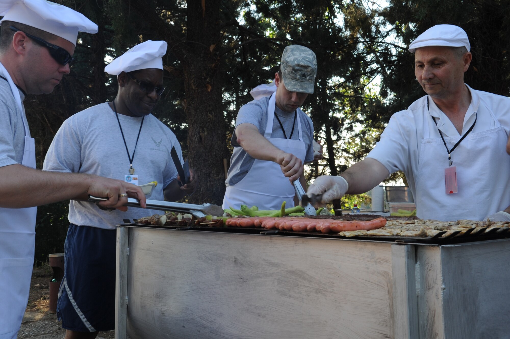 CAMP PEPELISHTE, Macedonia ? Members of the Top 3 organization cook for participants of the 2011 Medical Training Exercise in Central and Eastern Europe June 13. An annual Chairman of the Joint Chiefs of Staff-sponsored regional and multilateral exercise, MEDCEUR is designed to provide medical training and operational experience in a deployed environment for U.S. and partner nations. The countries participating in this year's MEDCEUR are Macedonia, Montenegro, Bosnia and Herzegovina, Serbia, Slovenia and Norway. (U.S. Air Force photo/Staff Sgt. Nadine Y. Barclay)