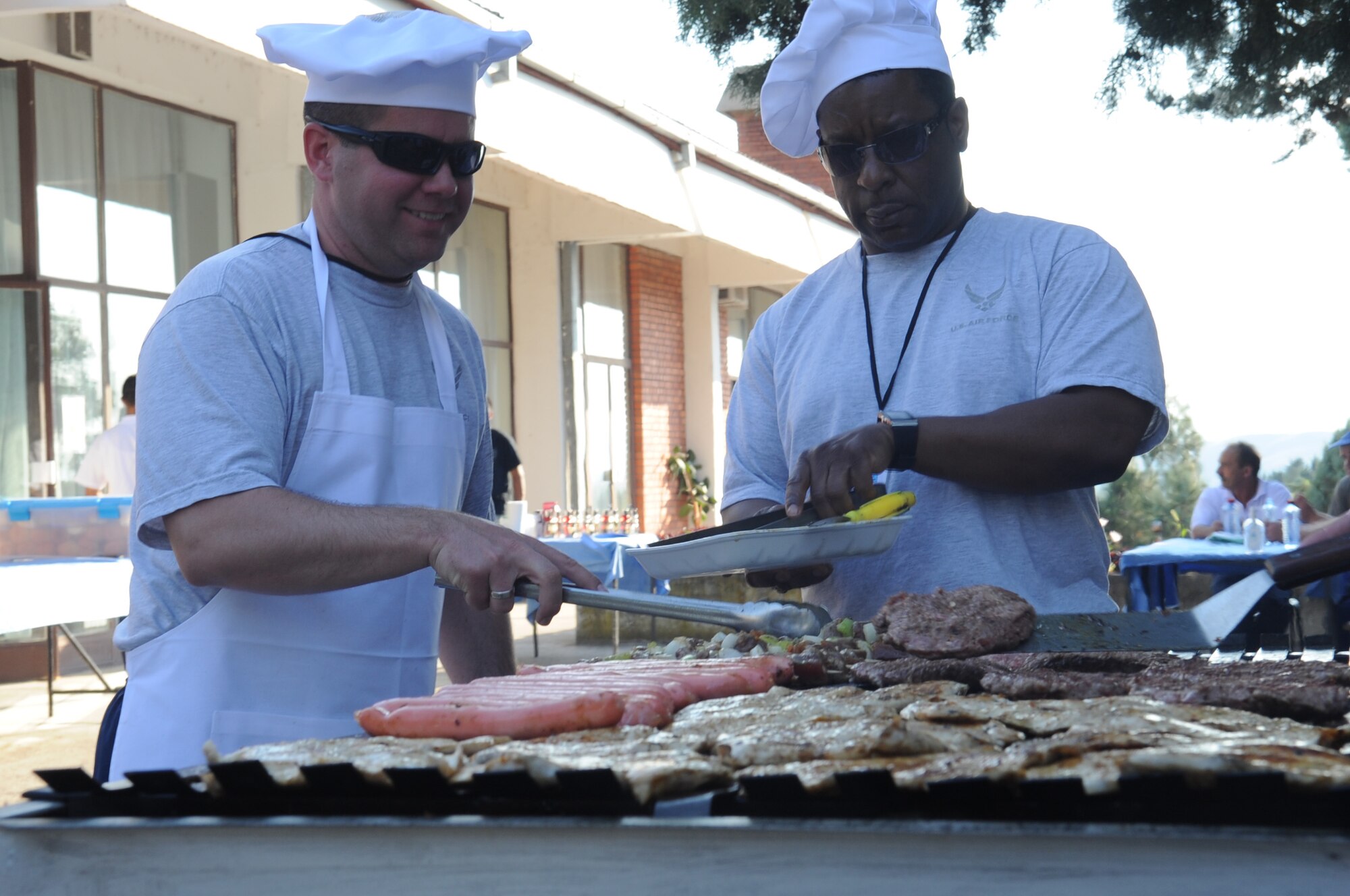 CAMP PEPELISHTE, Macedonia ? Members of the Top 3 organization cook for participants of the 2011 Medical Training Exercise in Central and Eastern Europe June 13. An annual Chairman of the Joint Chiefs of Staff-sponsored regional and multilateral exercise, MEDCEUR is designed to provide medical training and operational experience in a deployed environment for U.S. and partner nations. The countries participating in this year's MEDCEUR are Macedonia, Montenegro, Bosnia and Herzegovina, Serbia, Slovenia and Norway. (U.S. Air Force photo/Staff Sgt. Nadine Y. Barclay)