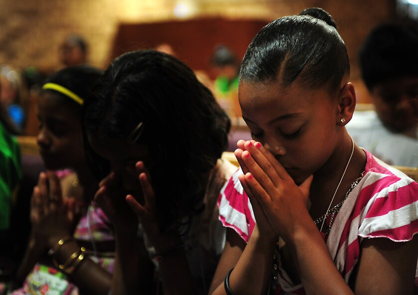 Latalyia Qutaishat prays in the chapel before the start of Pandamania Vacation Bible School at Moody Air Force, Ga., June 14, 2011. The students started the day off with a prayer and learned the verse of the day. (U.S. Air Force Senior Airman Stephanie Mancha/Released)   