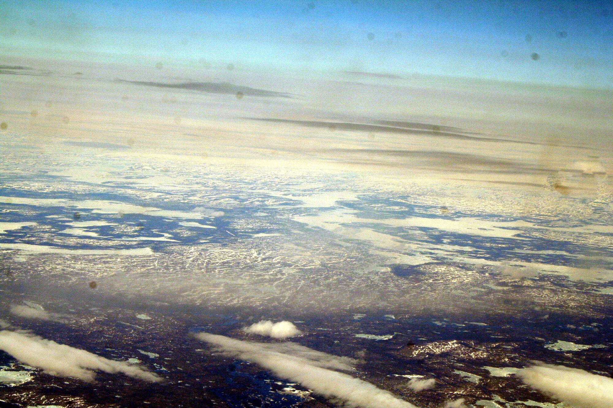 Ice-covered areas are seen from above the Arctic Circle from the window of a C-5M Super Galaxy on a  mission from Dover Air Force Base, Del., on June 5, 2011. The C-5M's mission was to complete the first Arctic overflight from Dover AFB to Bagram Airfield, Afghanistan. The plane successfully landed at Bagram just over 15 hours later on June 6, 2011. (U.S. Air Force Photo/Master Sgt. Scott T. Sturkol)