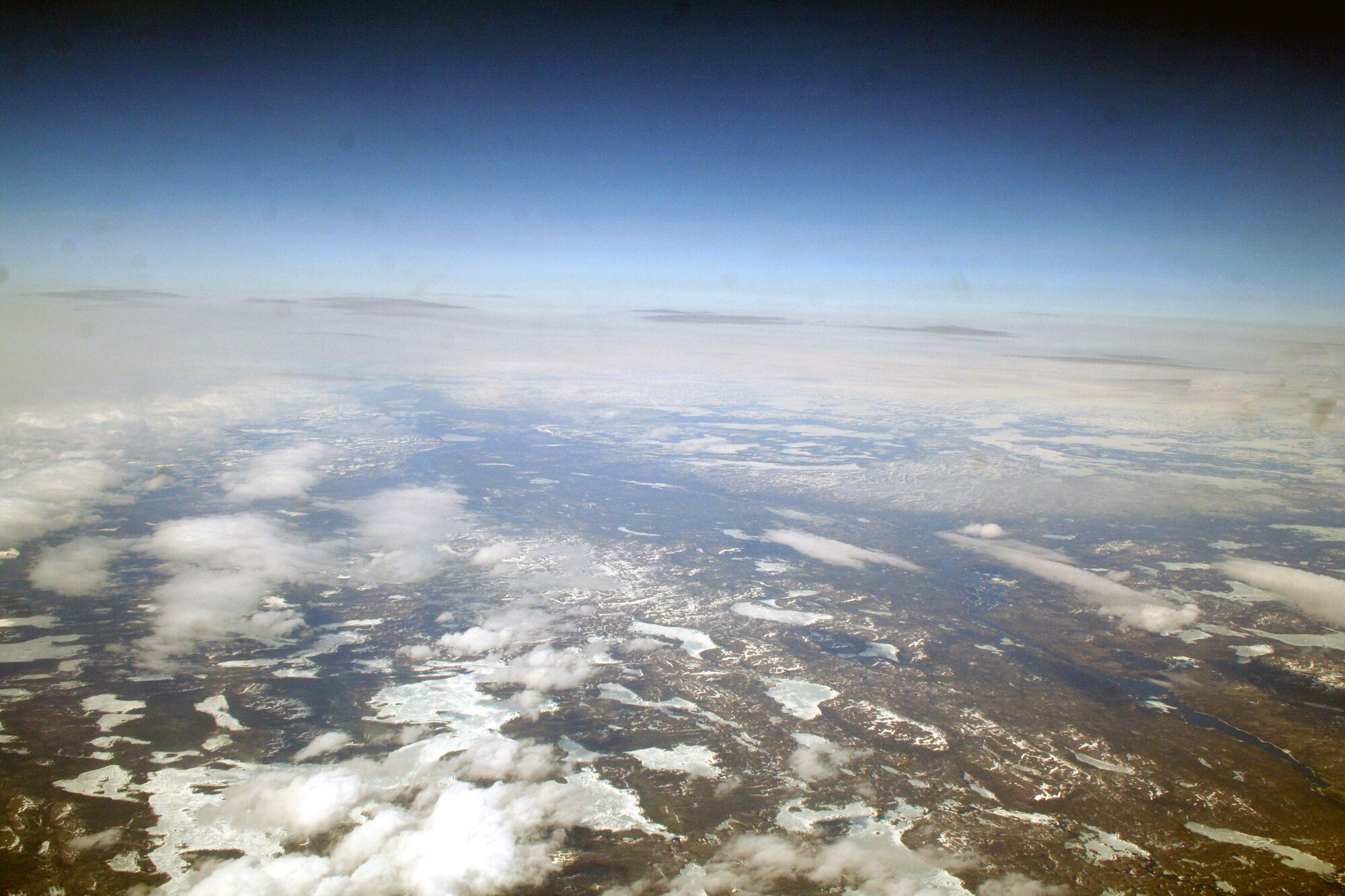 Ice-covered areas are seen from above the Arctic Circle from the window of a C-5M Super Galaxy on a  mission from Dover Air Force Base, Del., on June 5, 2011. The C-5M's mission was to complete the first Arctic overflight from Dover AFB to Bagram Airfield, Afghanistan. The plane successfully landed at Bagram just over 15 hours later on June 6, 2011. (U.S. Air Force Photo/Master Sgt. Scott T. Sturkol)