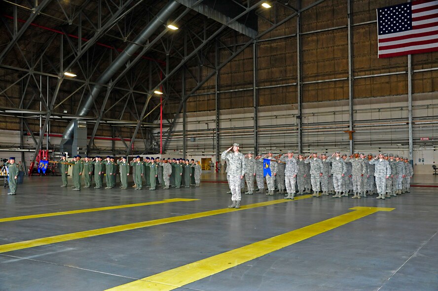 Members of the 62nd Airlift Wing render a salute to Col. R. Wyn Elder for the first time as the new 62nd Airlift Wing commander during the 62nd AW Change of Command Ceremony June 14 at Joint Base Lewis-McChord, Wash. (U.S. Air Force photo/Staff Sgt. Frances Kriss)