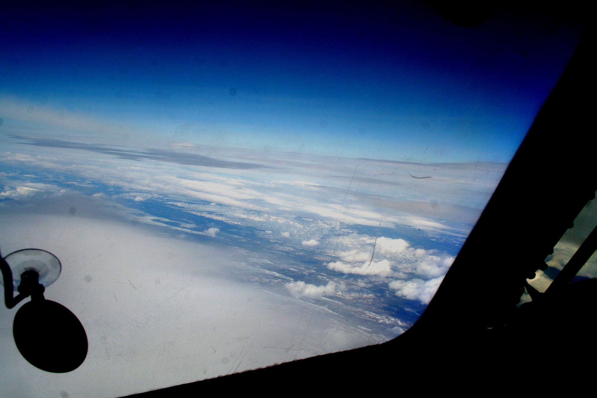 Ice-covered areas are seen from above the Arctic Circle from the window of a C-5M Super Galaxy on a  mission from Dover Air Force Base, Del., on June 5, 2011. The C-5M's mission was to complete the first Arctic overflight from Dover AFB to Bagram Airfield, Afghanistan. The plane successfully landed at Bagram just over 15 hours later on June 6, 2011. (U.S. Air Force Photo/Master Sgt. Scott T. Sturkol)