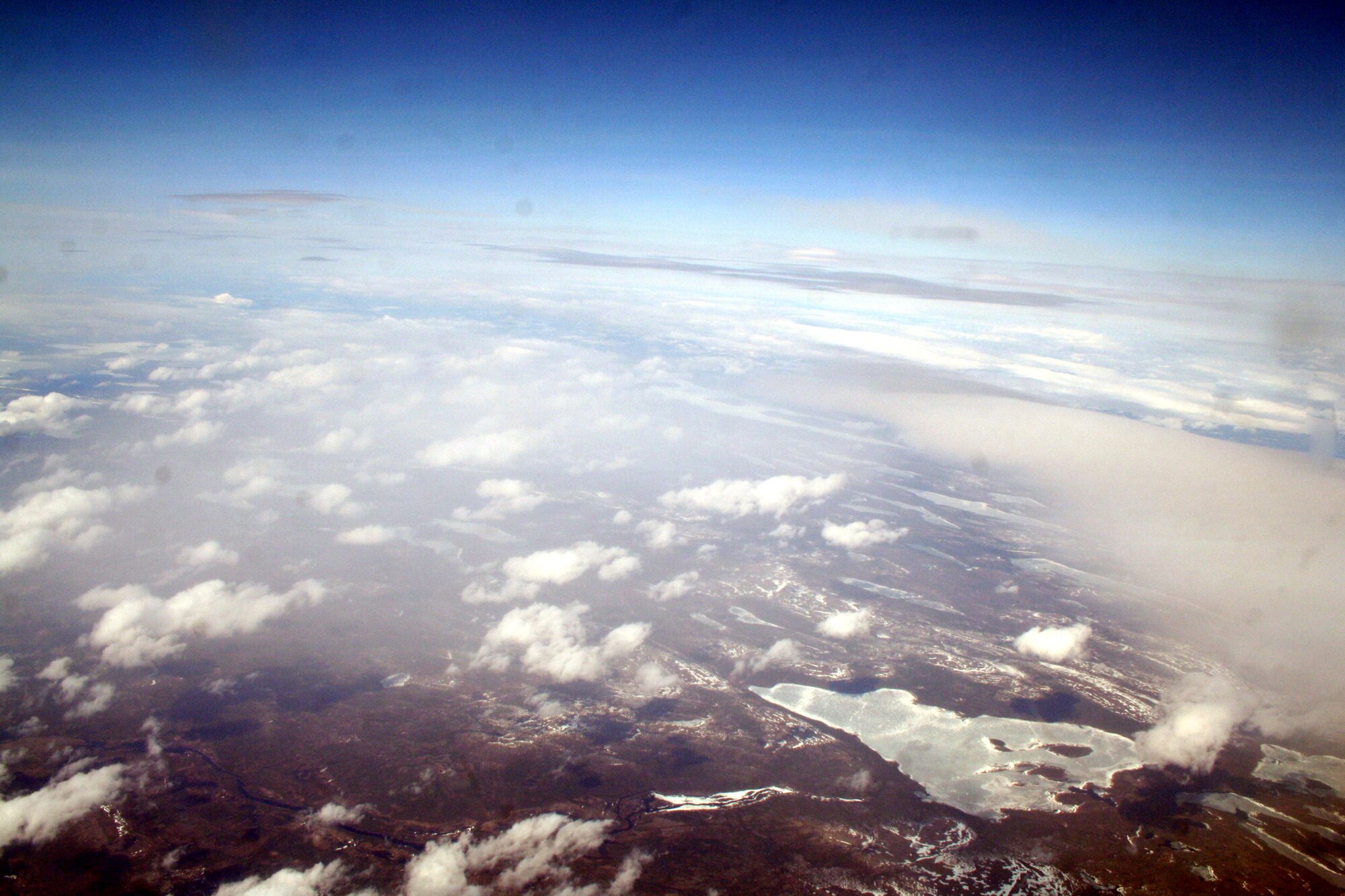 Ice-covered areas are seen from above the Arctic Circle from the window of a C-5M Super Galaxy on a  mission from Dover Air Force Base, Del., on June 5, 2011. The C-5M's mission was to complete the first Arctic overflight from Dover AFB to Bagram Airfield, Afghanistan. The plane successfully landed at Bagram just over 15 hours later on June 6, 2011. (U.S. Air Force Photo/Master Sgt. Scott T. Sturkol)