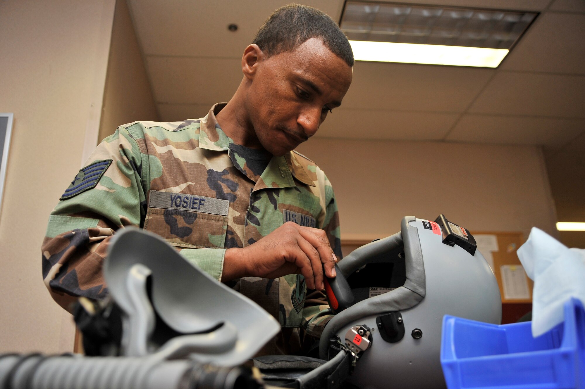 Tech Sgt. Filmon Yosief inspects a helmet during NORTHERN EDGE 2011 June 13, Eielson Air Force Base, Alaska. NORTHERN EDGE provides effective, flexible and capabilities-centered joint forces ready for deployment worldwide and enables real world proficiency in detection and tracking of units at sea, in the air and on land, in response to multiple crises. Sergeant Yosief is an aircrew flight equipment technician assigned to the 18th Operations Support Squadron, Kadena Air Base, Japan. (U.S. Air Force photo/Staff Sgt. Christopher Boitz)