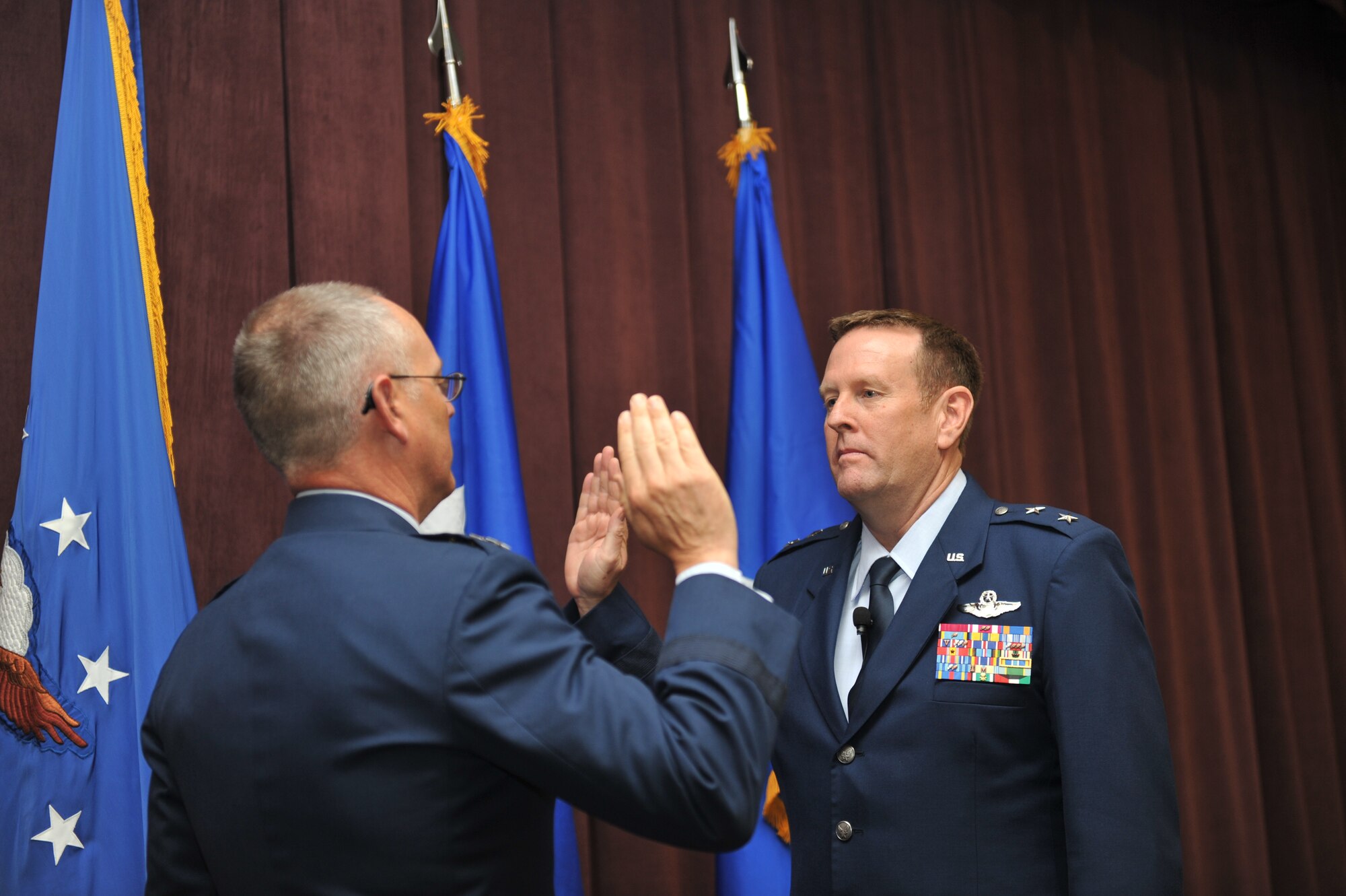 SCOTT AFB, Ill. - Lt. Gen. Robert R. Allardice, Commander, 18th Air Force, administers the Oath of Office to Maj. Gen. Robert K. Millmann, Jr., shortly after his promotion on June 10, 2011. 