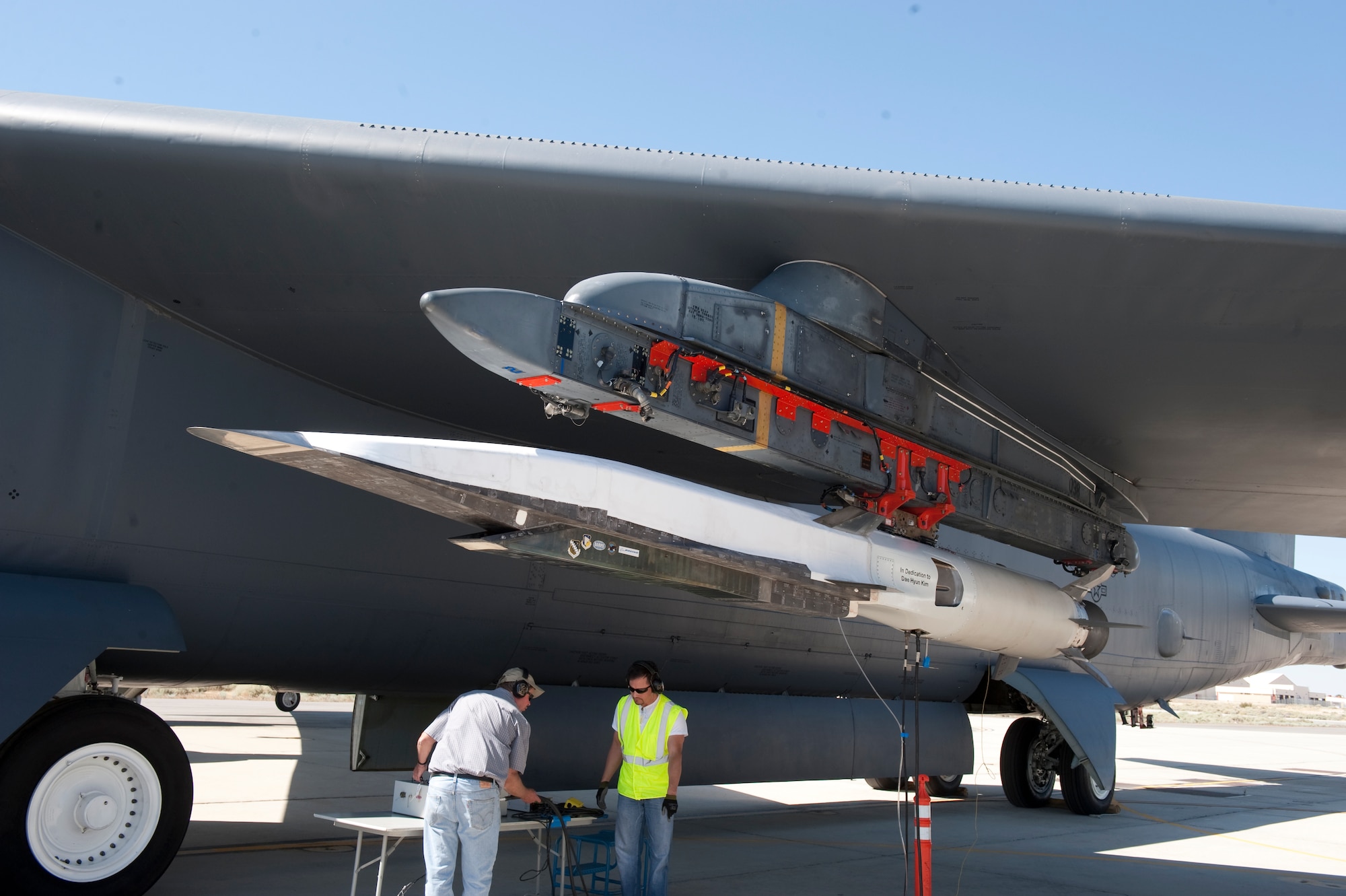 Ground crew members make the final checks to the X-51A Waverider scramjet, which is affixed to an Edwards B-52H Stratofortress before being flow over the Pacific Ocean and launched June 13. (Photo by Bob Ferguson/Boeing)