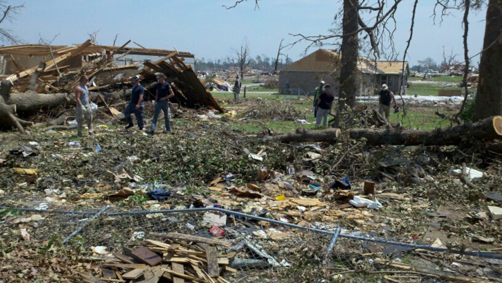 JOPLIN, Mo. -- Volunteers, some from Scott Air Force Base, survey the destruction June 2 caused by an EF5 tornado that passed through Joplin, Mo., May 22. The tornado left 153 people dead and damaged more than 8,000 homes, schools and the St. John’s Medical Center. (U.S. Air Force Photo by Tech. Sgt. Ed Mueller)