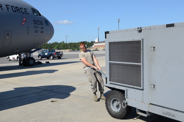 Senior Airman Darrik Ostrander pulls a power cart to a C-17 in order to apply power to the aircraft in preparation for Rodeo practice at Joint Base Charleston, June 10. The Rodeo team performs daily foreign object debris checks, inspections and maintenance on the C-17 specified as the command's Rodeo aircraft. Airman Ostrander is from the 437th Aircraft Maintenance Squadron and is a member of the 437th Airlift Wing 2011 Air Mobility Command Rodeo team. (U.S. Air Force photo/Tech. Sgt. Chrissy Best)

