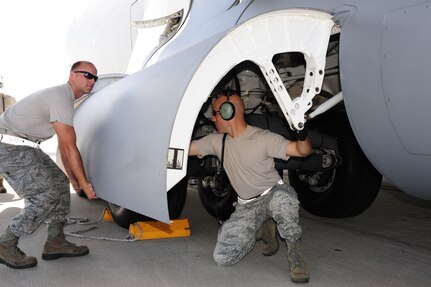 Staff Sgt. Brandon Padgett holds the right gear door as Tech Sgt. Travis Pyle releases the gear door to perform maintenance on a C-17 aircraft during  Rodeo practice at Joint Base Charleston, June 10. Both Airmen are assigned to the 437th Aircraft Maintenance Squadron and are members of the 437th Airlift Wing 2011 Air Mobility Command Rodeo team. (U.S. Air Force photo/Tech. Sgt. Chrissy Best)
