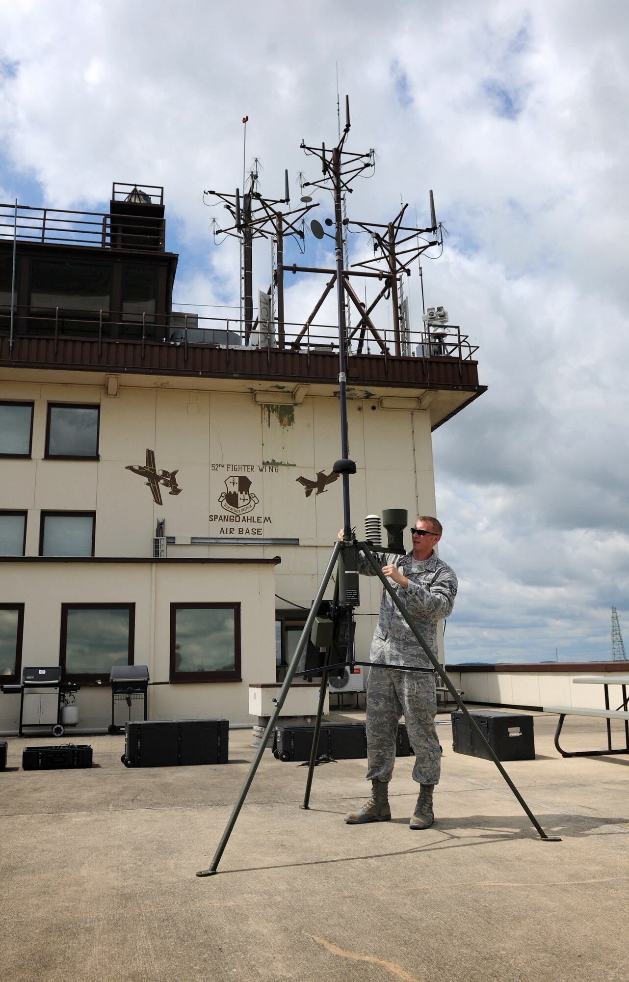 SPANGDAHLEM AIR BASE, Germany – Staff Sgt. Adam Cook, 52nd Operations Support Squadron weather technician, sets up a TMQ-53 automated observing weather station here June 14. The weather station automatically takes readings and processes the readings through a computer, which provides weather technicians more time to analyze weather data. (U.S. Air Force photo/Senior Airman Nathanael Callon)