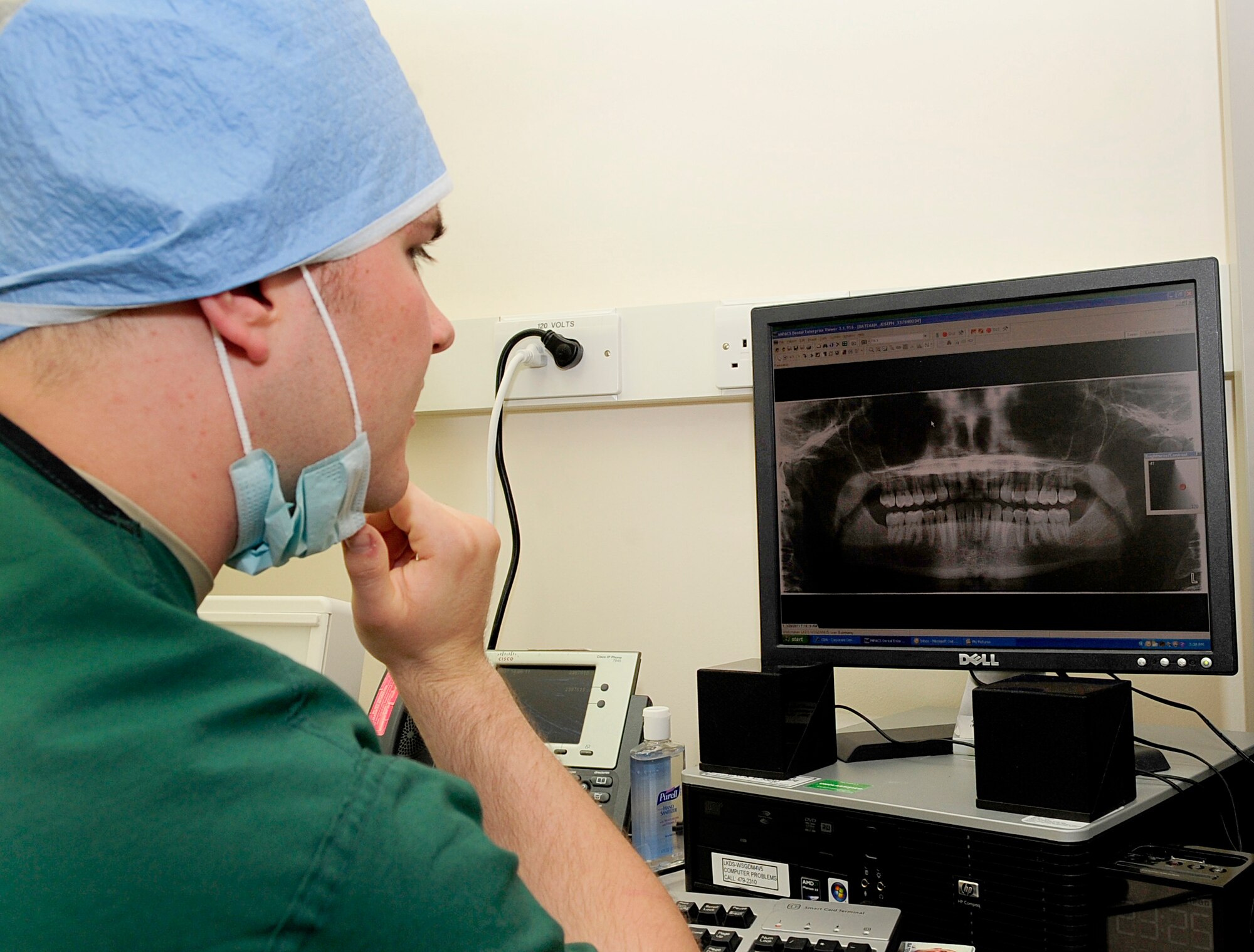 RAF MILDENHALL, England -- Senior Airman Joseph Bateman, 48th Dental Squadron technician, checks a patient's X-rays for a routine cleaning here June 14, 2011. The X-rays of each patient are checked before each treatment to confirm the patient's identity, check for abnormalities and to insure there are no risk factors for the treatment. (U.S. Air Force photo/Senior Airman Ethan Morgan)