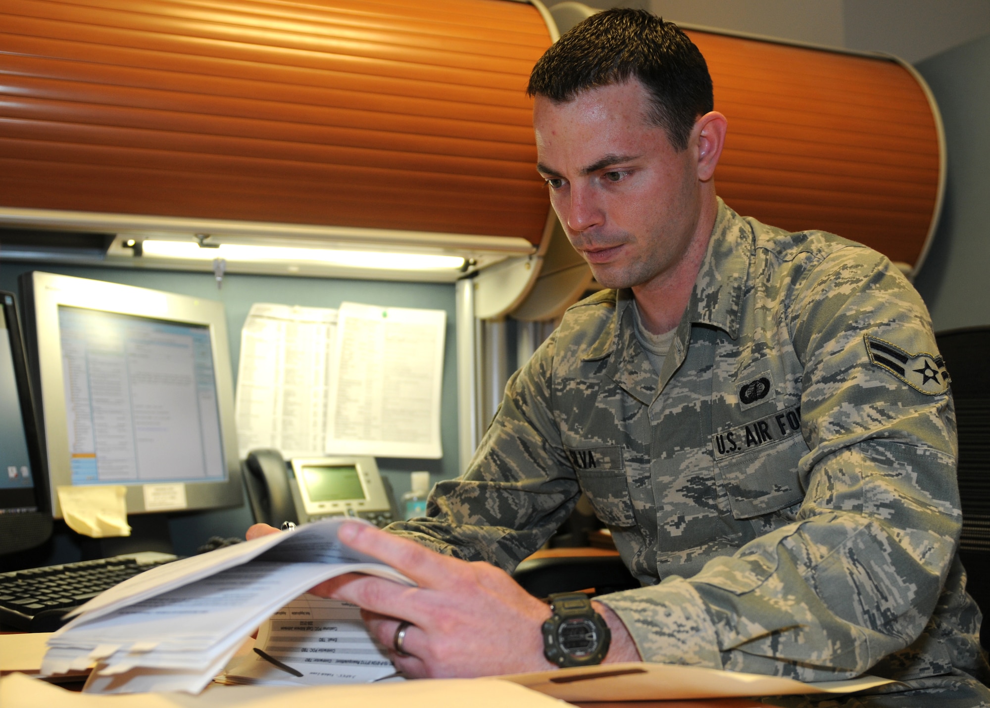 ROYAL AIR FORCE LAKENHEATH, England -- Airman 1st Class Garrett Silva, 48th Contracting Squadron contracting specialist, reviews paperwork on June 15, 2011. Airman Silva was nominated for a Liberty Spotlight because he displays the core value of 'Excellence in All We Do'. (U.S. Air Force photo/ Airman Cory Payne)