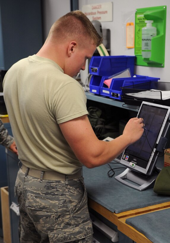 Airman 1st Class Mitchell Scarbrough, 811th Operation Support Squadron aircrew flight equipment technician, checks technical orders for a helmet he is inspecting for functionality and serviceability.  AFE inspects and maintains other equipment as well, to include night vision goggles, life preservers and survival kits. (U.S. Air Force photo by Senior Airman Torey Griffith)