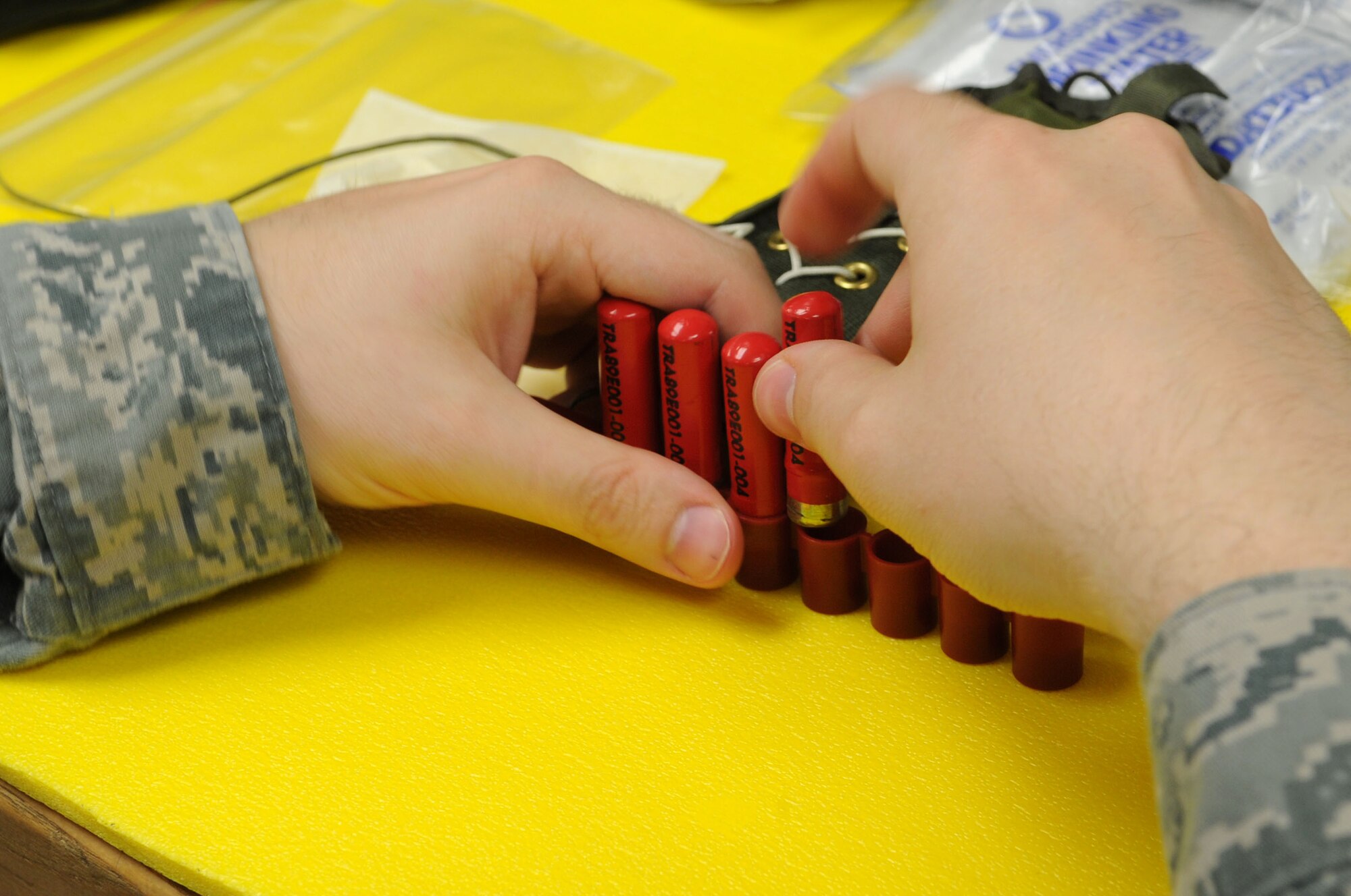 Staff Sgt. Stuart McCallum, 811th Operation Support Squadron aircrew flight equipment technician, packs flares for a survival kit.  The AFE team inspects and maintains equipment such as flight helmets, night-vision goggles, life vests and survival kits.  (U.S. Air Force photo by Senior Airman Torey Griffith)