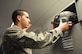 Airman 1st Class Richard Rodriguez, 811th Operation Support Squadron aircrew flight equipment technician, stows a flight helmet in a pilot's locker after he inspected it for function and servicability.  AFE inspects and maintains other equipment as well, to include night-vision goggles, life preservers and survival kits. (U.S. Air Force photo by Senior Airman Torey Griffith)(released)
