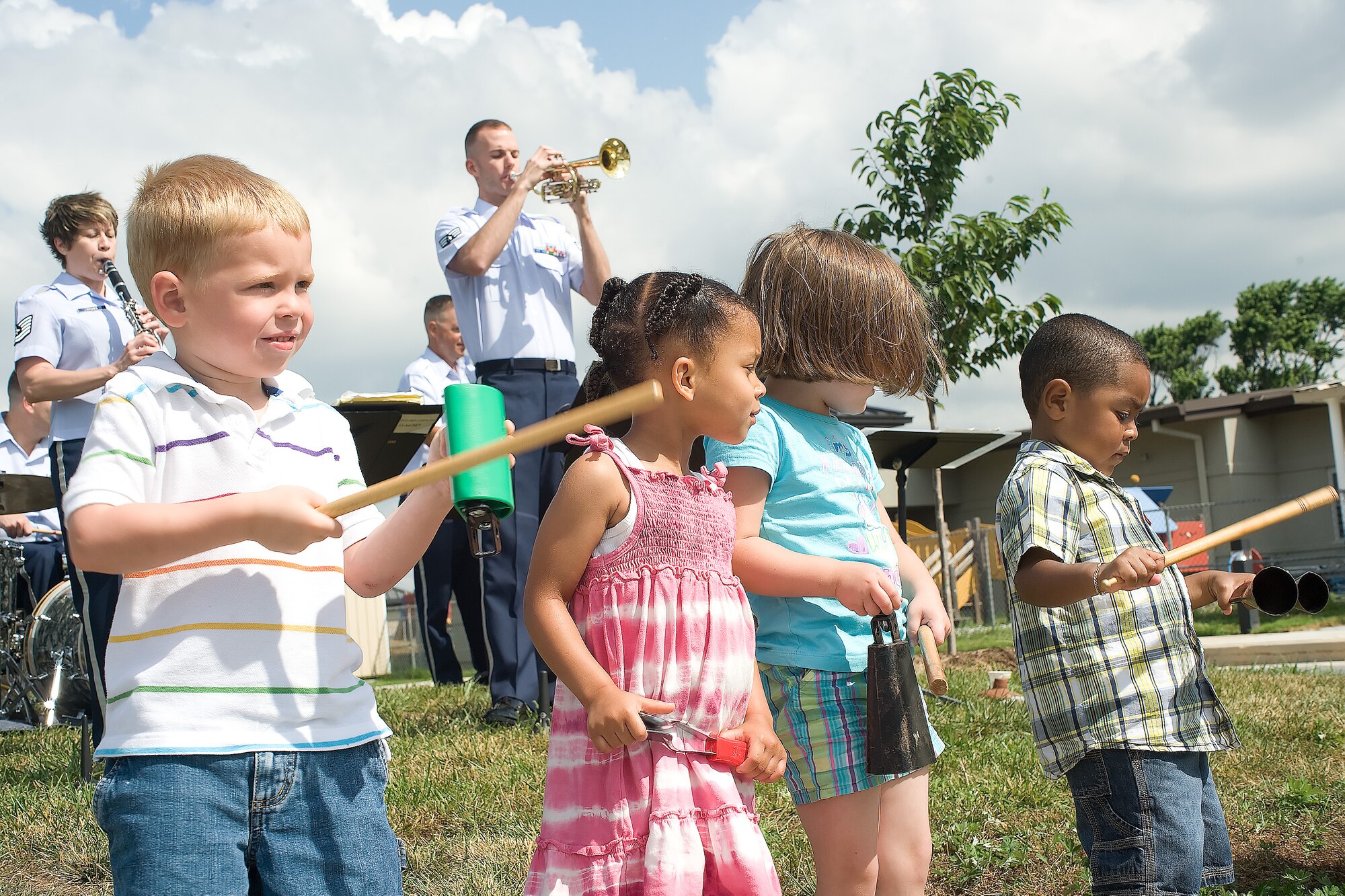 The Heritage of America Band Ramblers Dixieland Ensemble performs for children at the Child Development Center June 14, 2011, at Dover Air Force Base, Del. The band is composed of Tech. Sgt. John Garcia on the trombone, Senior Master Sgt. JR Erb on string bass, Tech. Sgt. Lacey Stokes on clarinet, Staff Sgt. Gary Steinberg on drums, Senior Airman Aaron Weibe on guitar and Senior Airman Amy Chicavich on vocals. (U.S. Air Force photo by Adrian Rowan)