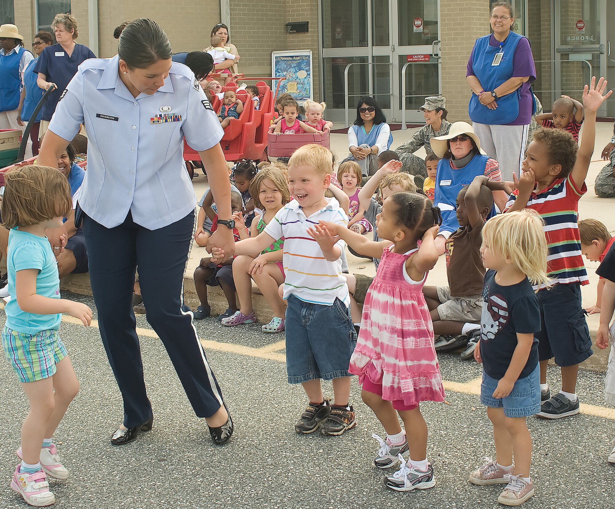 Senior Airman Amy Chicavich, Heritage of America Band Ramblers Dixieland Ensemble, brings children from the Child Development Center to the stage to play instruments June 14, 2011, at Dover Air Force Base, Del. The Heritage of America Band was on tour in Delaware and stopped by to entertain Team Dover members. (U.S. Air Force photo by Adrian Rowan)