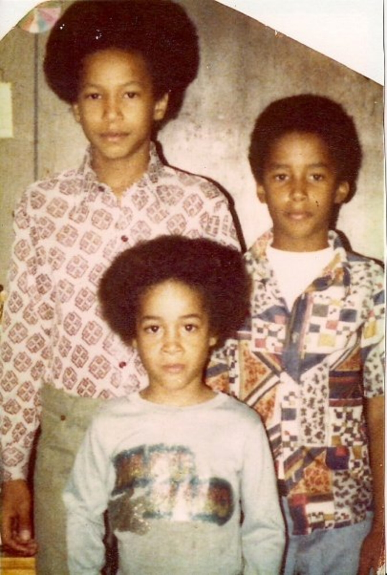 KABUL, Afghanistan – Senior Master Sgt. Donaldo Puller, senior noncommissioned officer in charge of personnel (left) poses with his brother Capt. Jay Harris, 438th Air Expeditionary Wing, (front) and their third brother Melvin Harris in a family photo taken in 1978.  Sergeant Puller and Captain Harris were recently reunited at Kandahar Air Base in Afghanistan.  (U.S. Air Force courtesy photo)