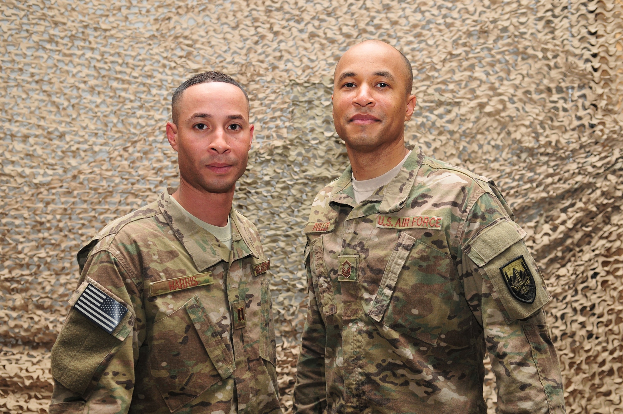 6/12/2011 – KANDAHAR, Afghanistan – Capt. Jay Harris, 438th Air Expeditionary Wing and Senior Master Sgt. Donaldo Puller, senior noncommissioned officer in charge of personnel, stand together while visiting Kandahar Air Base recently.  The brothers are both stationed in Colorado Springs, Colo at Schriever Air Force Base and Peterson AFB.  Sergeant Puller will redeploy in seven more months while Captain Harris nears the end of his year-long deployment.  (U.S. Air Force photo by Tech. Sgt. Brian E. Christiansen)