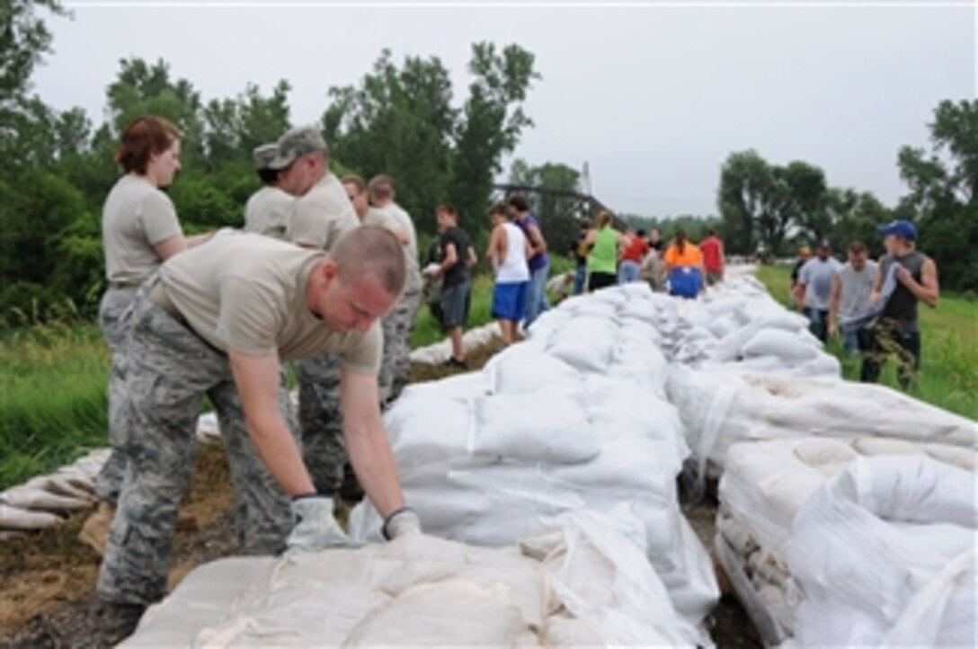 U.S. Air Force airmen with the Missouri National Guard's 139th Airlift Wing stack sandbags on a levee near Rosecrans Memorial Airport in preparation for flooding in Missouri on June 10, 2011.  