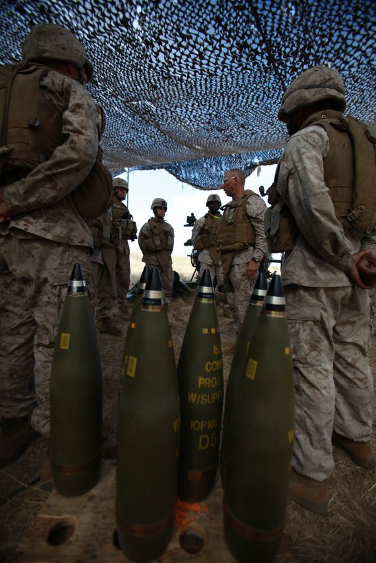 Marines with Kilo Battery, Battalion Landing Team 3/1, listen as Sergeant Maj. Scott T. Pile, 11th Marine Expeditionary Unit sergeant major, speaks to them during a field exercise here June 15. The purpose of the exercise is to prepare the unit for its upcoming deployment.