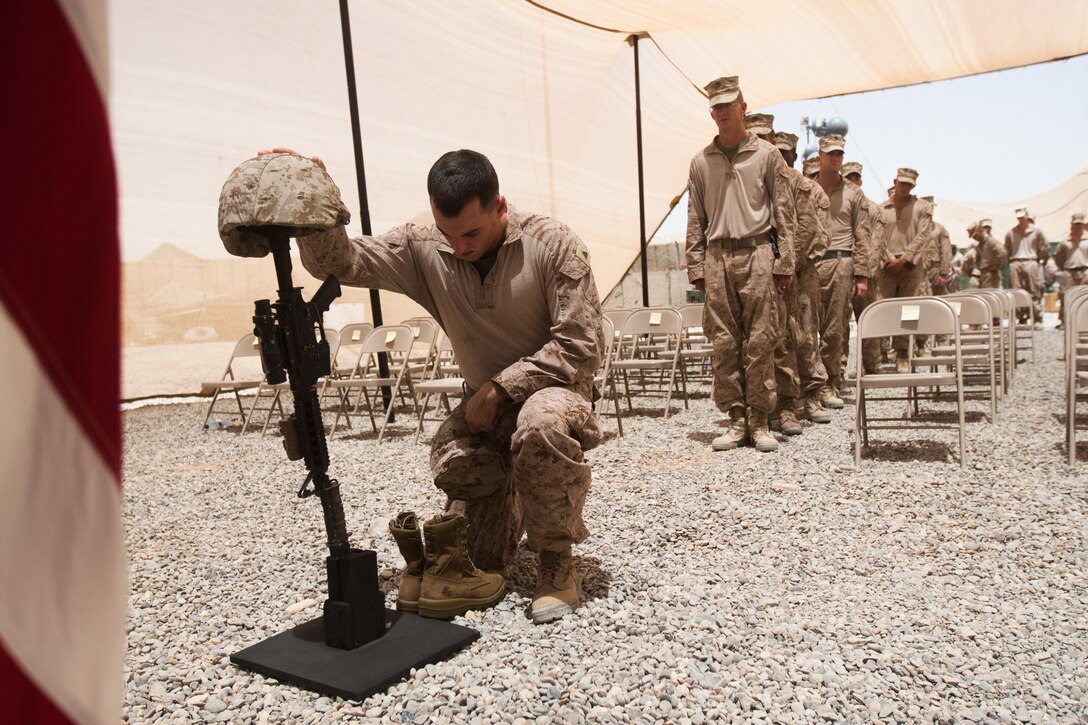 Marines with 2nd Battalion, 8th Marine Regiment pay their final respects to Sgt. Joseph Garrison, a squad leader with Fox Company, 2/8, during a memorial service here, June 15. Garrison, a native of Clarion, Pa., made the ultimate sacrifice during combat operations in Northern Marjah, June 6.