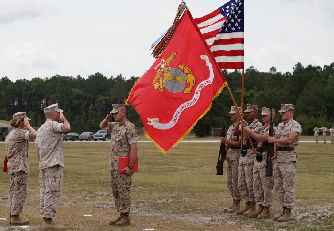 Lt. Col. Chris S. Richie, center, and Marine Air Control Squadron 2 Marines salute during the playing of the national anthem at the MACS-2 change of command ceremony at the squadron parade field June 16. Richie relinquished command to Lt. Col. Darry W. Grossnickle.