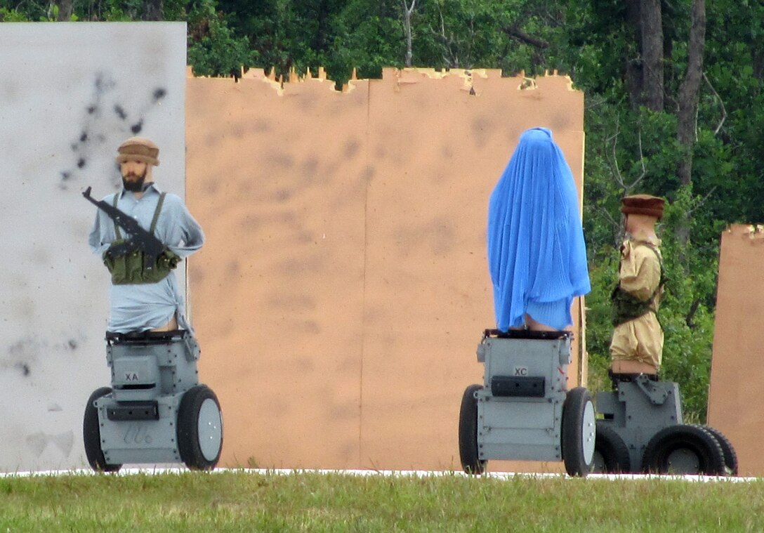 The Robotic Moving Target System (R-MTS) includes the T20 (two robots on the left) which has two wheels and weighs 400 pounds and the T40 which weighs 520 pounds and has four wheels. Both systems have armor plating on their chassis that can withstand 5.56mm and 7.62mm bullets. Above the armored chassis are the targets, lifelike, 3D plastic mannequins that can withstand hundreds of shots.