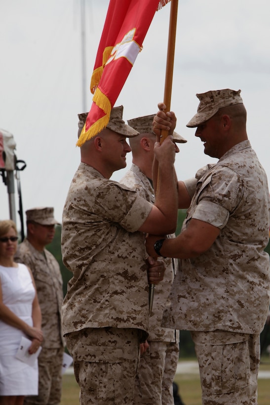 Lt. Col. Chris S. Richie, left, passes the Marine Air Control Squadron 2 colors to Sgt. Maj. Alex M. Dobson, right, during the squadron’s change of command ceremony at the MACS-2 parade field June 16. Richie relinquished command to Lt. Col. Darry W. Grossnickle.
