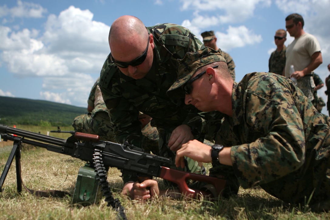 During a foreign weapons familiarization, Cpl. Nicholas Porter, an Amarillo, Texas, native and rifleman with Black Sea Rotational Force 11, gets a brief introduction to the Bulgarian-issued Dragunov machine gun from Bulgarian Capt. Svetoslav Godinov, company commander of the Bulgarian infantry battalion participating in the combat marksmanship range. The Ground Combat Element of BSRF-11 conducted counterinsurgency and peacekeeping operations with Bulgarians and Serbians to work with foreign soldiers and build the military capacities of partner nations.