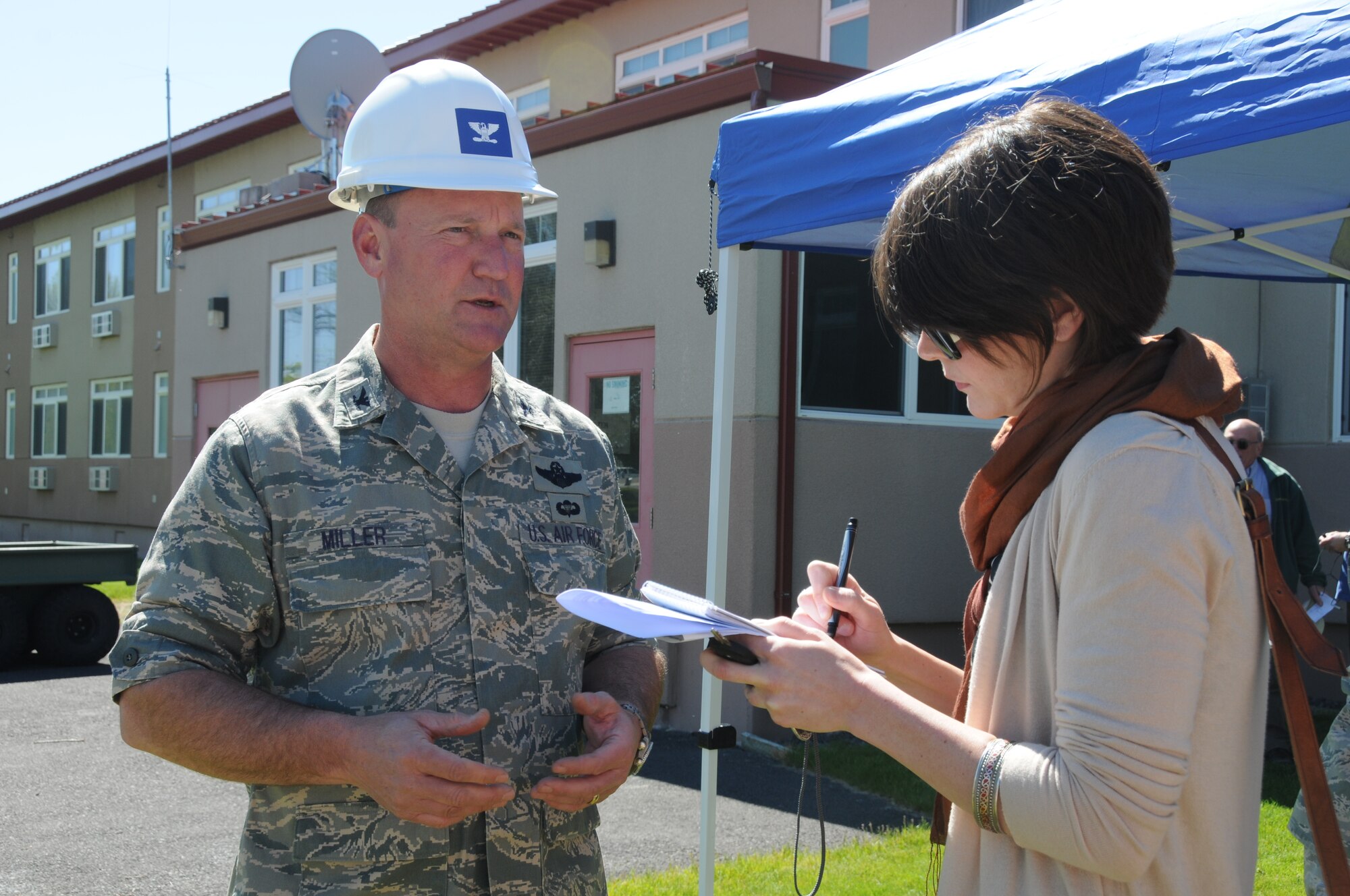 Col. James Miller, 173rd Fighter Wing Commander, is interviewed by Herald and News reporter Sara Hottman June 9, 2011 at Kingsley Field, Klamath Falls, Ore. during the ground breaking ceremony for the Joint Armed Forces Reserve Center.  When completed the building will house the 173rd Security Forces Squadron and Charlie Troop, 1-82nd Cavalry, Oregon Army National Guard.  (U.S. Air Force Photo by Tech. Sgt Jennifer Shirar) RELEASED