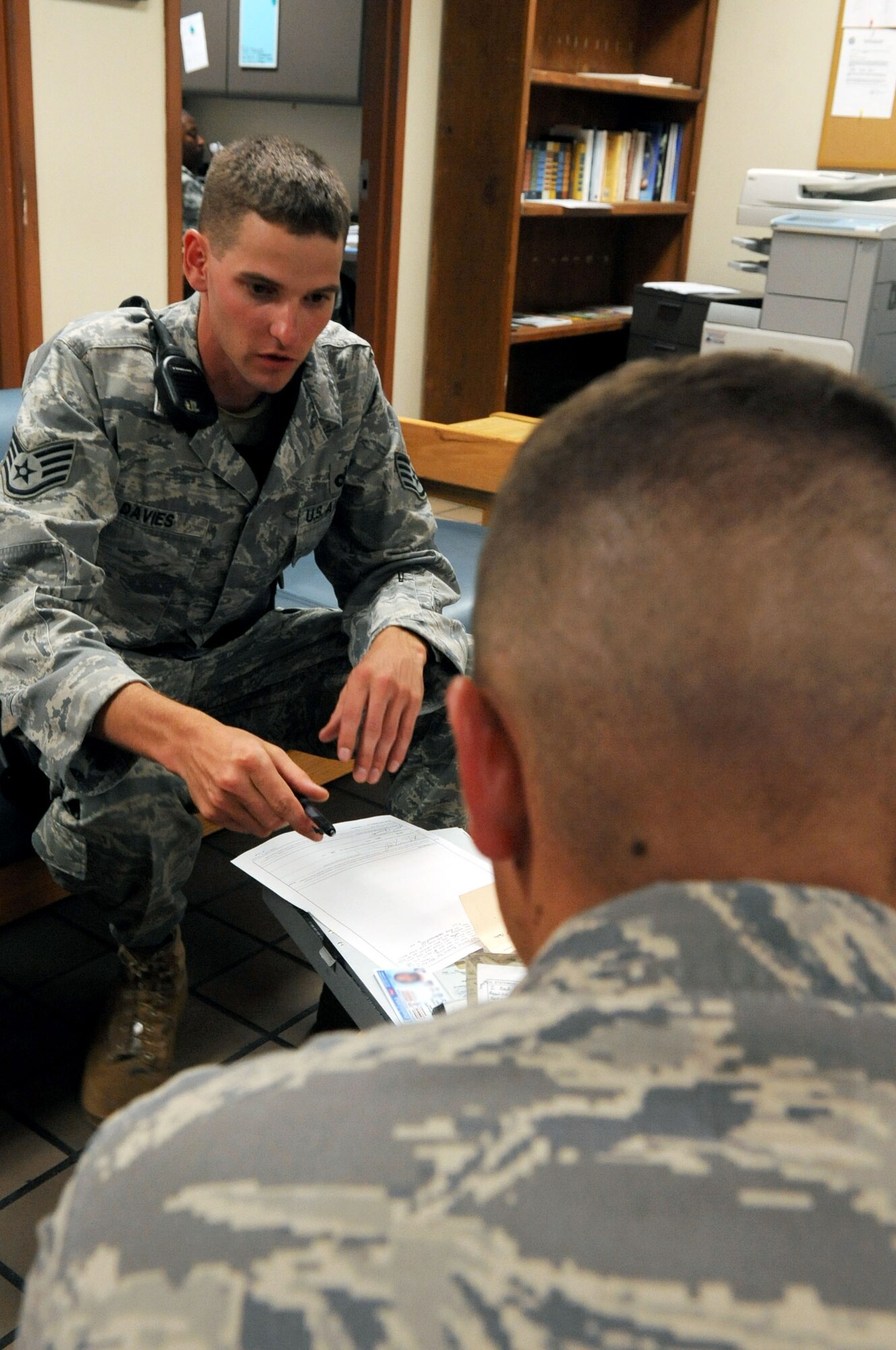 Staff Sgt. Jeremy Davies, 2nd Security Forces Squadron, reads the oath signature statement from an accident form with an airman at the 2nd Logistics Readiness Squadron on Barksdale Air Force Base, La., June 16. The Airman was an eyewitness to an accident. (U.S. Air Force photo/Senior Airman La'Shanette V. Garrett) (RELEASED)