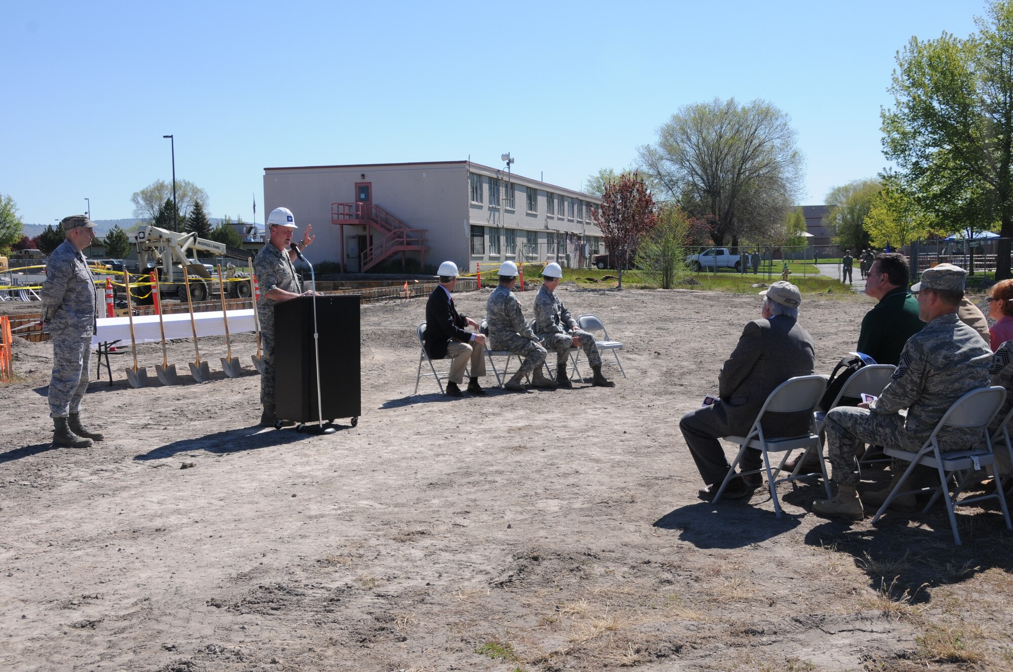 Col. James Miller, 173rd Fighter Wing Commander, points to the outdated bulding behind him that currently houses the 173rd Security Forces Squadron June 9, 2011 at Kingsley Field, Klamath Falls, Ore. during the ground breaking ceremony for the Joint Armed Forces Reserve Center.  When completed the building will house the 173rd Security Forces Squadron and Charlie Troop, 1-82nd Cavalry, Oregon Army National Guard.  (U.S. Air Force Photo by Tech. Sgt Jennifer Shirar) RELEASED