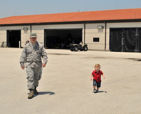 PATRICK AIR FORCE BASE, Fla. - Capt. Ryan Liss, public affairs officer, 920th Rescue Wing here, and his toddler son, Ben, walk in step during the June unit training assembly. Captain Liss is new to the Air Force Reserve as he recently transfered from active duty. As an Air Force Reservist, Captain Liss will now serve as a Citizen Airmen, part civilian, part Reservist. (U.S. Air Force photo/Capt. Cathleen Snow)