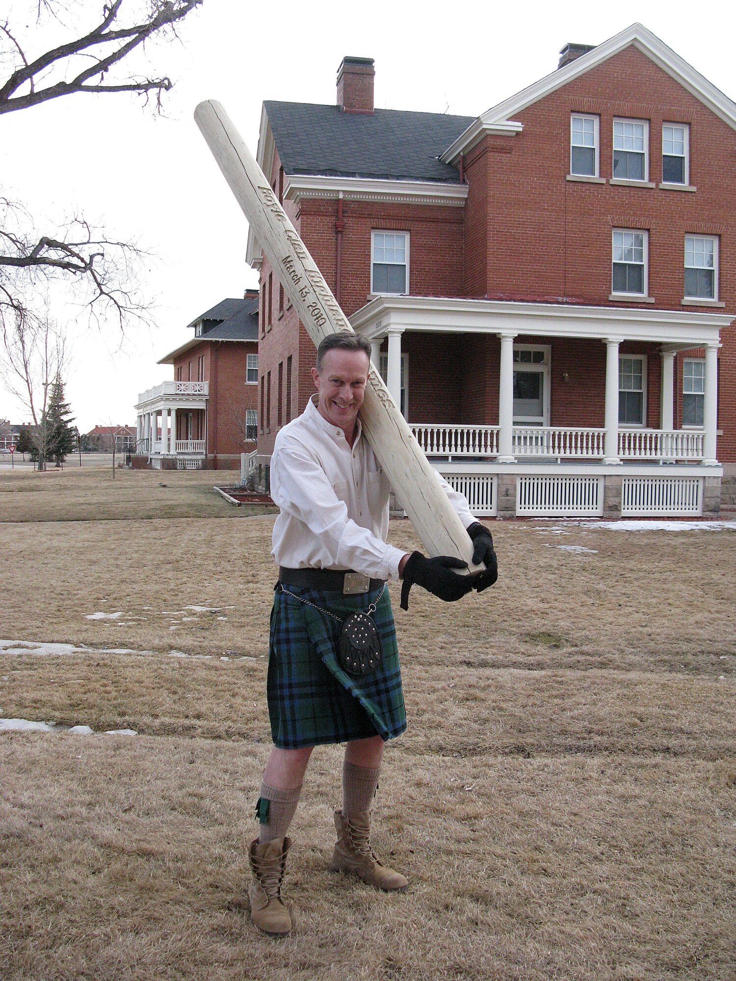 Col. John Boyle, 90th Mission Support Group commander, participates in the caber toss during his Pink Flamingo party for St. Patrick's Day here in 2010. (Courtesy photo)