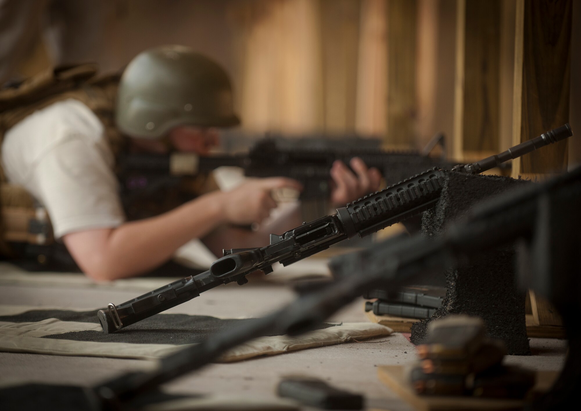An M4 carbine rifle lies on the ground at the combat arms shooting range during quarterly training for members of the Air Force Office of Special Investigations Detachment 211 at Moody Air Force Base, Ga., June 16, 2011. The M4 is a gas-operated, air-cooled, magazine-fed, selective fire weapon with a telescoping stock. (U.S. Air Force photo by Airman 1st Class Joshua Green/Released)
