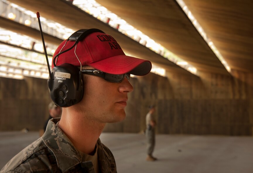 U.S. Air Force Staff Sgt. Justin Krenzelok, 23rd Security Forces Squadron combat arms training and maintenance instructor, observes members of the Air Force Office of Special Investigations Detachment 211 fire rounds during their quarterly combat arms training at Moody Air Force Base, Ga., June 16, 2011. Sergeant Krenzelok overlooked the combat arms training and tested the AFOSI member during qualification. (U.S. Air Force photo by Airman 1st Class Joshua Green/Released)
