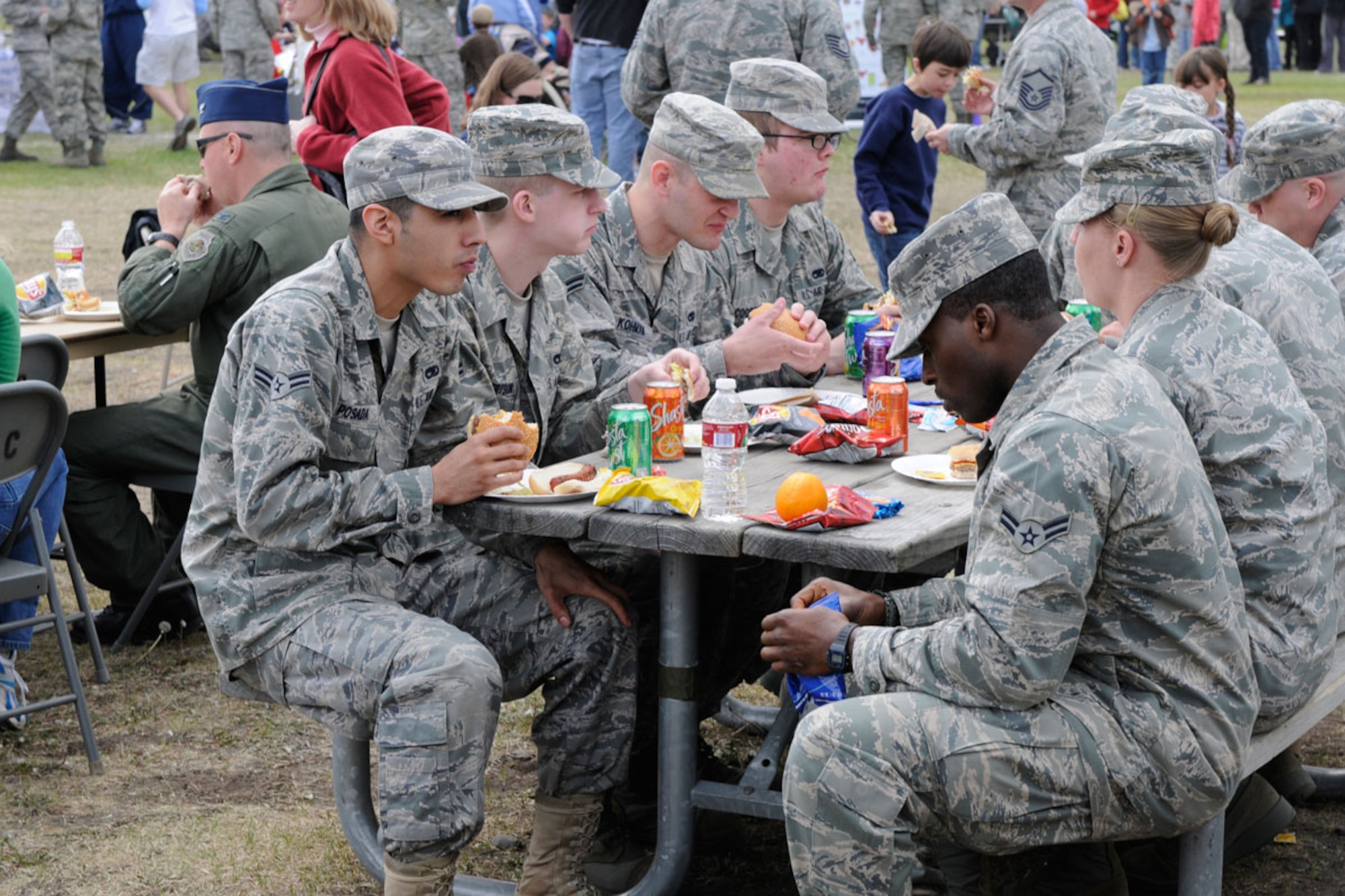 Airmen take a break for lunch at the free picnic during the JBER Military Appreciation Day events. The picnic was sponsored by the Anchorage Chamber of Commerce, and more than 150 volunteers turned out to support JBER. (U.S. Air Force photo\Steve White)
