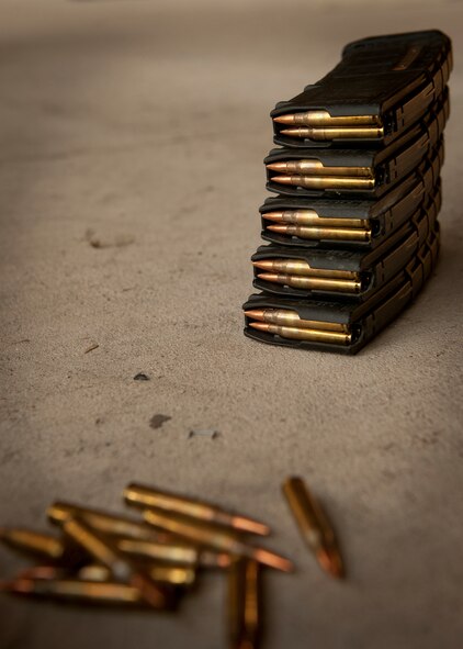 Magazine cartridges holding 5.56 mm rifle ammo sits on the ground at the combat arms shooting range during quarterly combat arms training and maintenance for members of the Air Force Office of Special Investigations Detachment 211 at Moody Air Force Base, Ga., June 16, 2011. The bullet rifle is a cartridge developed in the United States and is the standard cartridge for NATO forces as well as many non-NATO countries. (U.S. Air Force photo by Airman 1st Class Joshua Green/Released)
