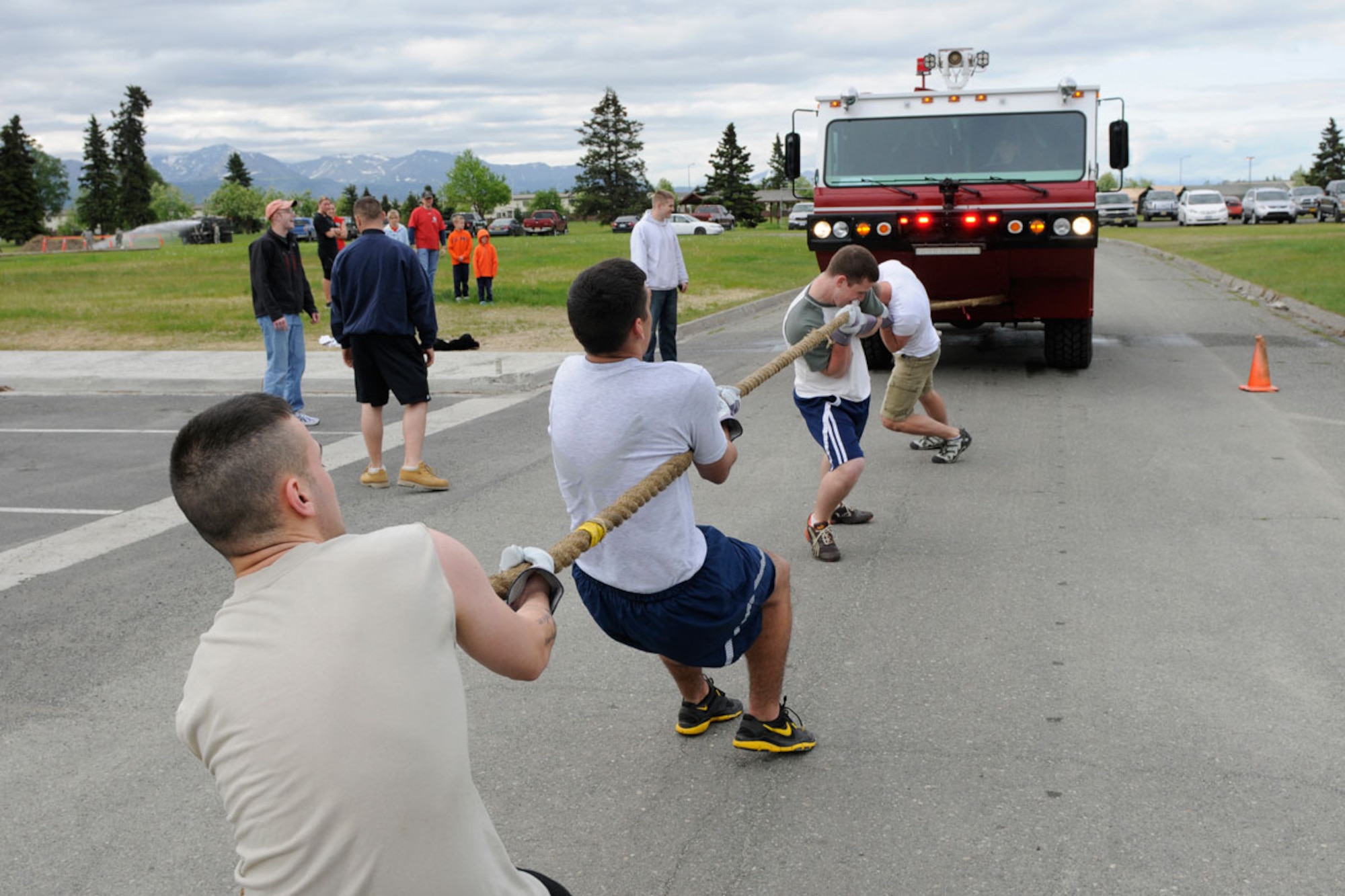 Three members of the 381st Intelligence Squadron and one assigned to the 673d Aircraft Maintenance Squadron attempt to pull a fire truck at the Arctic Warrior  Olympics at Joint Base Elmendorf-Richardson June 10. (U.S. Air Force photo\Steve White)
