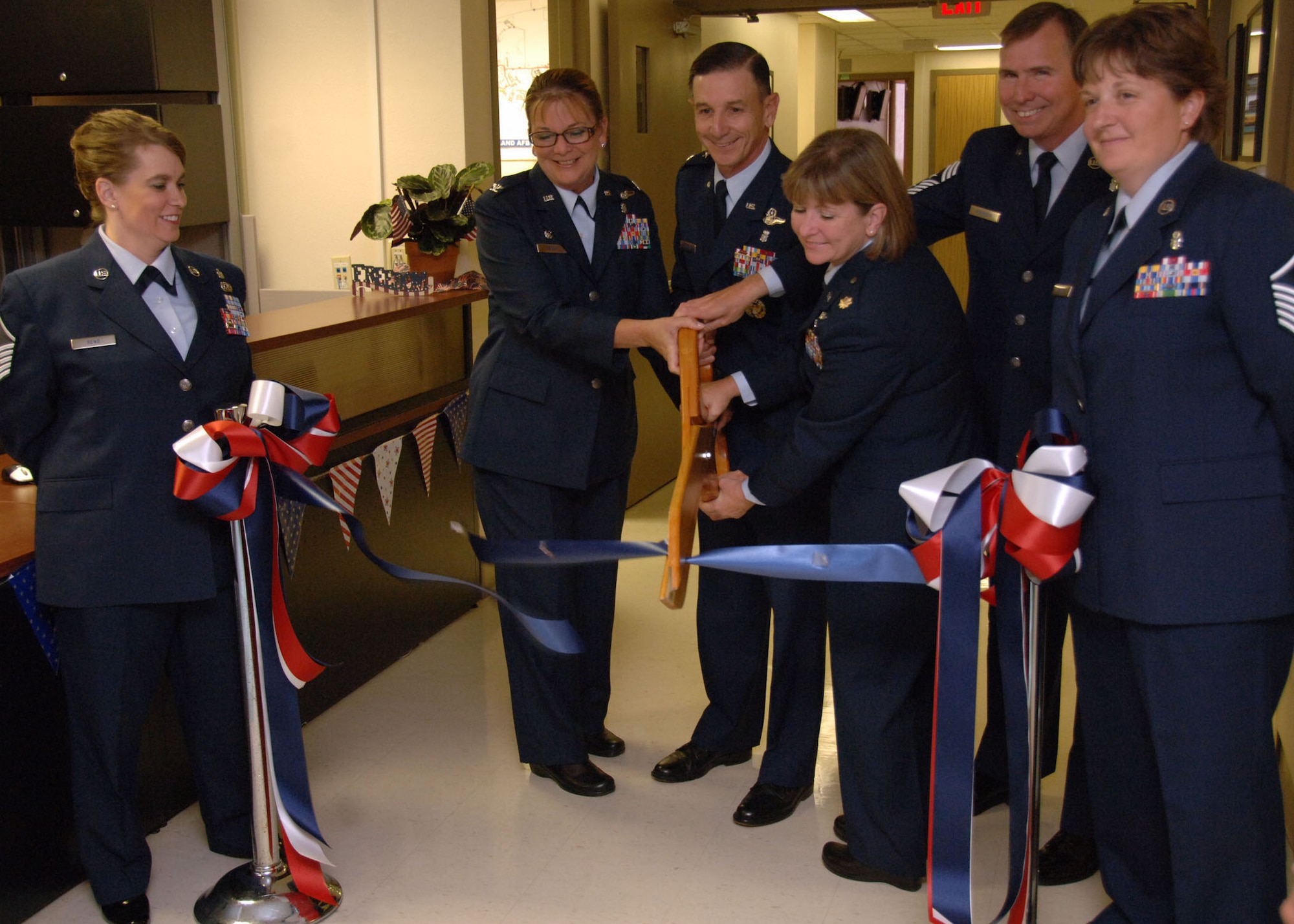 Air Force senior leaders opened the 59th Contingency Aeromedical Staging Facility  with a ribbon cutting ceremony June 13, 2011, at Wilford Hall Medical Center, Lackland Air Force Base,Texas. The CASF mission will provide medical care and a comfortable holding area for wounded warriors while awaiting transporation to their final destiination. Cuttting the ribbon are (center, left to right) Air Force Reservist Col. Debora Esque, 59th CASF commander; Maj. Gen. Byron Hepburn, 59th MDW commander; Maj. Charlotte Knight, 59th CASF flight commander; and Chief Master Sgt. Richard Robinson, 59th MDW command chief, as CASF staff members watch. (U.S. Air Force photo/Senior Airman Kevin IInuma)