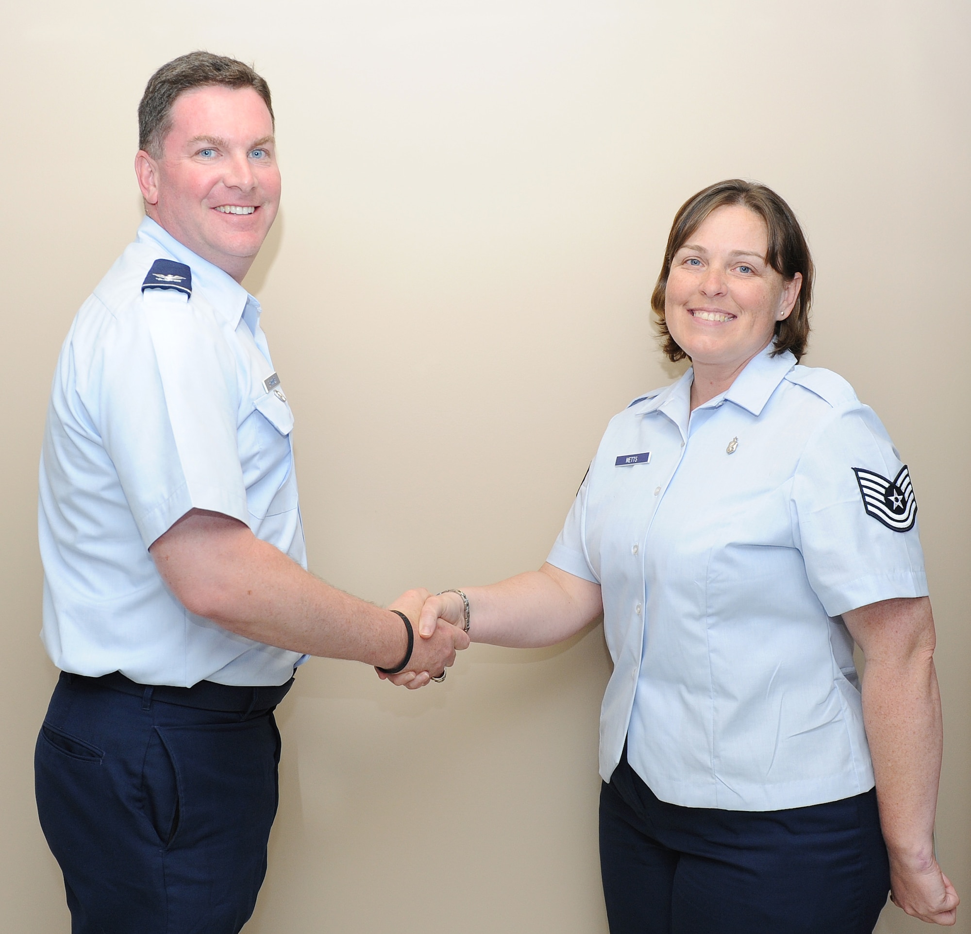 Col. Thomas Crimmins, 19th Airlift Wing vice commander, presents a commander’s coin June 13 to Tech. Sgt. Carla Metts, a 19th Medical Group life support program manager, for her selection as the Combat Airlifter of the Week at Little Rock Air Force Base, Ark. Sergeant Metts also coordinated medical coverage for all wing commander’s fun runs, retreat ceremonies and Mission Oriented Protective Posture, or MOPP, Monday activities. (U.S. Air Force photo/Airman 1st Class Ellora Remington)