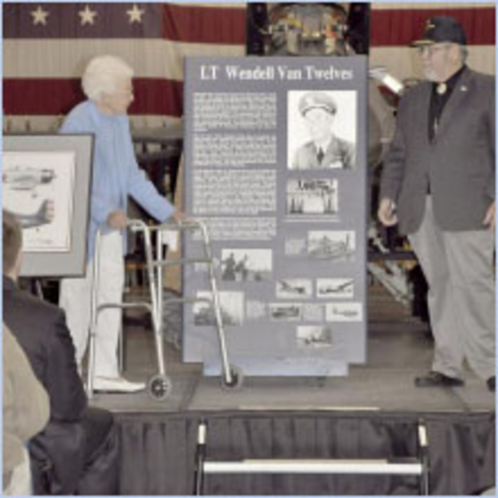 LaRhea Nielson Twelves, widow of Lt. Wendell Van Twelves, and Rear Adm. Jeremy Taylor (Ret.) unveil the plaque for Twelves' inclusion in the Utah Aviation Hall of Fame. (U.S. Air Force photo by Airman 1st Class Melissa Dearstone)