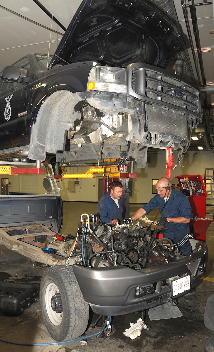 Staff Sergeant Jeffrey Strong (right), Vehicle Maintenance, Logistics Readiness Squadron, 146th Airlift Wing, Channel Islands Air National Guard Station, Calif., and Technical Sergeant Clint Miller, Vehicle Maintenance, 176th LRS, 176 Air Wing, Alaska Air National Guard, Joint Base Elmendorf-Richardson, Anchorage, work to replace a cylinder head gasket on a Security Forces pickup on June 14, 2011.The 146th AW sends three squadrons to JBER from June 4 to June 18, 2011. The Air Terminal Operations Squadron, Logistics Readiness Squadron, and the Security Forces Squadron move down range to complete their respective annual training requirements. Photo by Tech. Sgt. Alex Koenig