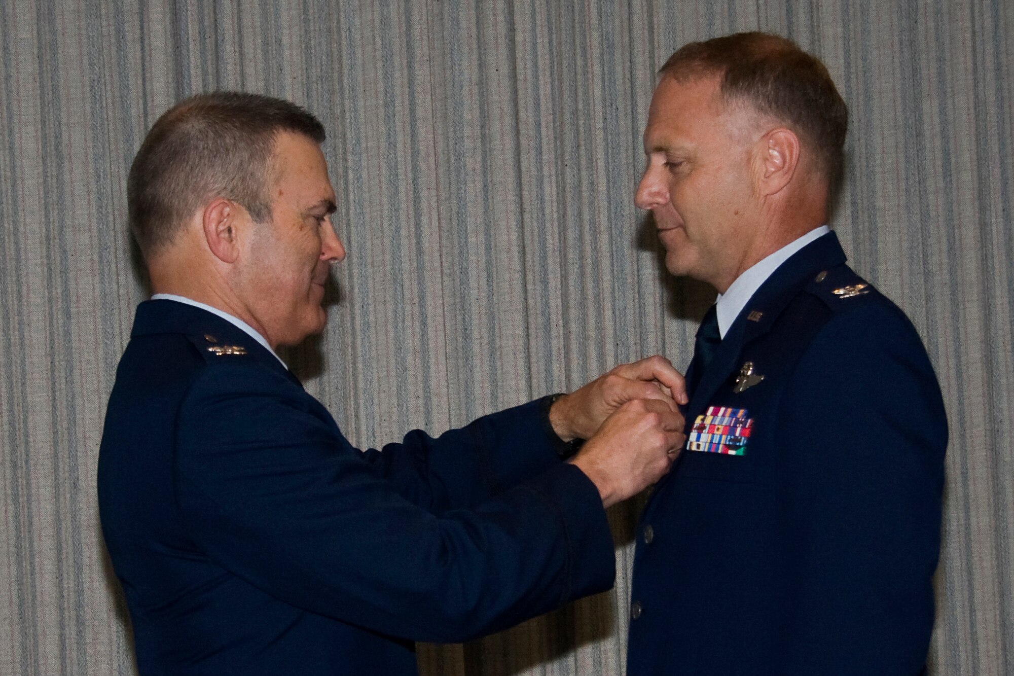 GRISSOM AIR RESERVE BASE, Ind. -- Col. William T. "Tim" Cahoon, 434th Air Refueling Wing commander, presents Col. Tim Cox with a Meritorious Service Medal during his retirement ceremony held here May 14. The Meritorious Service Medal was established in 1969 as the counterpart of the Bronze Star Medal for the recognition of meritorious noncombatant service and may be awarded to any member of the Armed Forces of the United States who distinguishes themselves by either outstanding achievement or meritorious service to the United States. Colonel Cox retired from the Air Force Reserve as the 434th Air Refueling Wing vice commander after 30 years of military service. (U.S. Air Force photo/Tech. Sgt. Mark R. W. Orders-Woempner)
