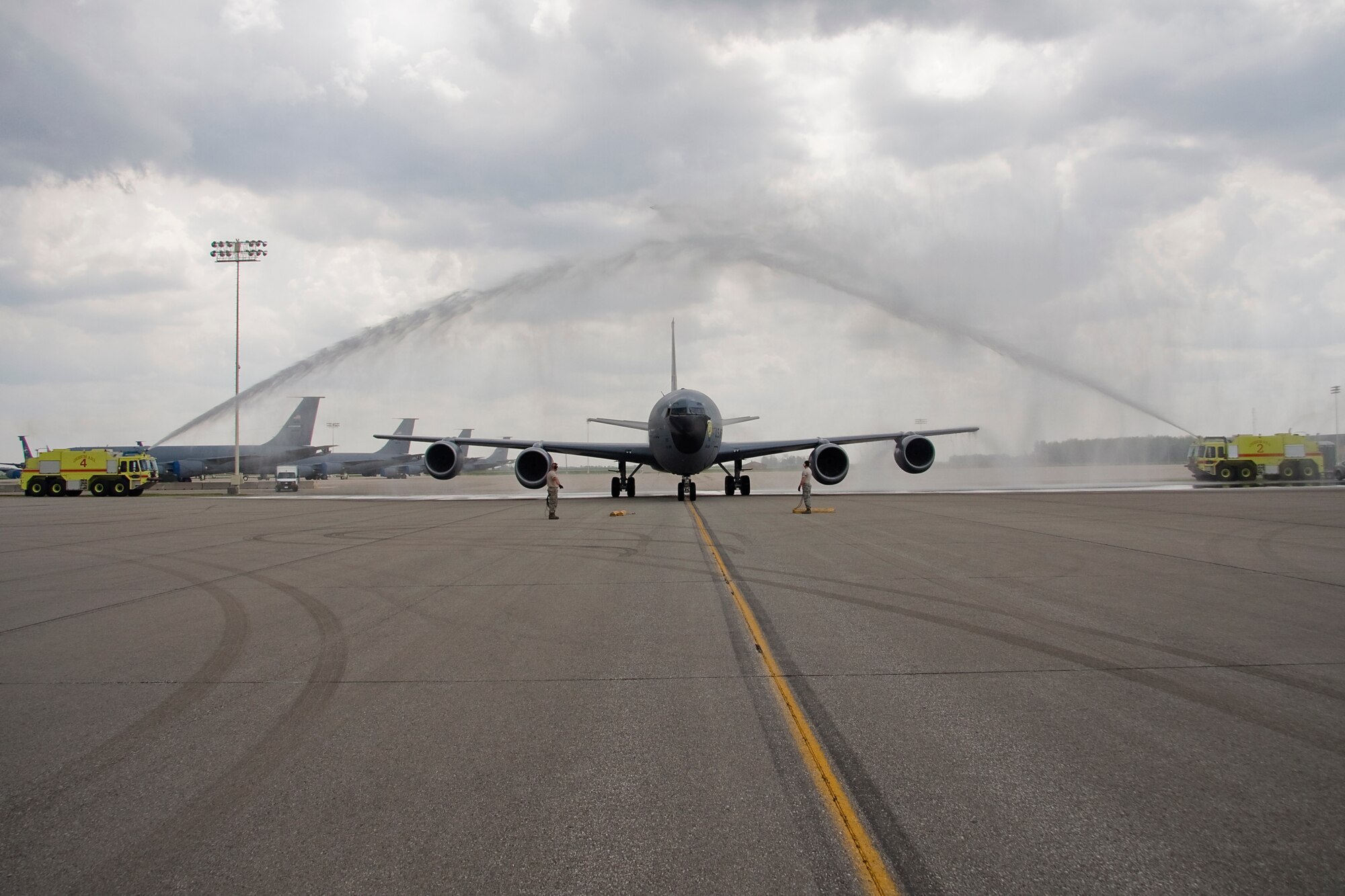 GRISSOM AIR RESERVE BASE, Ind. -- Fire trucks from Grissom's Fire Department create an arch by blasting their water cannons as they salute Col Tim Cox as he taxis a KC-135R Stratotanker aircraft to a parking spot after his final flight as an Air Force Reserve pilot May 13. Colonel Cox, 434th Air Refueling Wing vice commander, retired from the Air Force Reserve after 30 years of military service. (U.S. Air Force photo/Tech. Sgt. Mark R. W. Orders-Woempner) 
