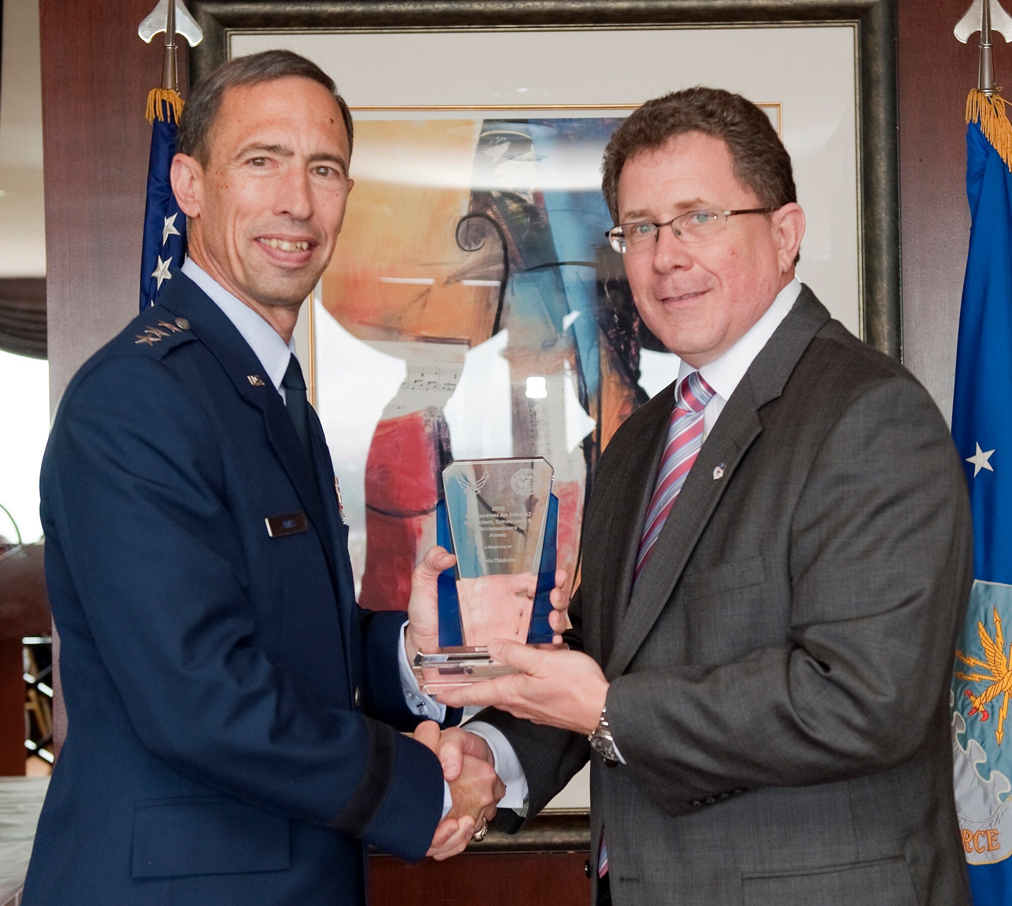 Lt. Gen. Larry James, U.S. Air Force Headquarters Deputy Chief of Staff for Intelligence, Surveillance and Reconnaissance, presents the award for Outstanding Intelligence, Surveillance and Reconnaissance Senior-Level Civilian of the Year to Kevin Chisholm, 1st Special Operations Support Squadron Intelligence Flight deputy commander, during a ceremony in Washington, D.C.  Mr. Chisholm and three other Air Commandos earned Air Force Intelligence, Surveillance and Reconnaissance Agency awards for outstanding leadership and performance in their respective career fields.  (Courtesy photo)
