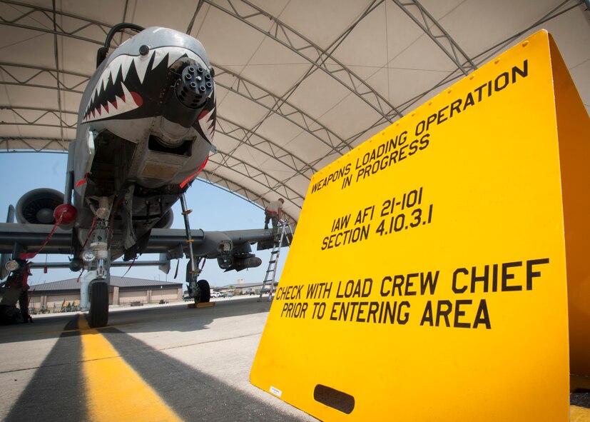 A caution sign sits outside the hangar of an A-10C Thunderbolt II during a phase II operational readiness exercise flying surge at Moody Air Force Base, Ga., June 15. The exercise was conducted to prepare the wing for an upcoming operational readiness inspection. (U.S. Air Force photo by Senior Airman Benjamin Wiseman/Released)
